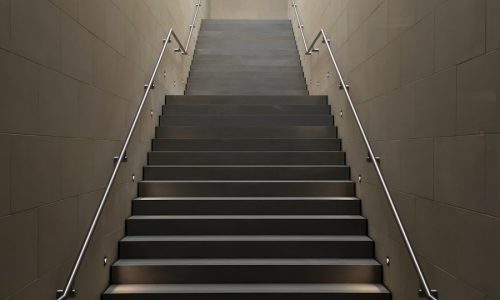 gray concrete stair with gray steel handle